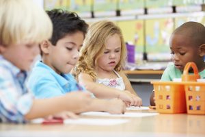 Group Of Elementary Age Children In Art Class